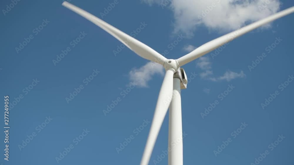 Wind generator on bright cloudy sky background Wind generator on bright cloudy sky background