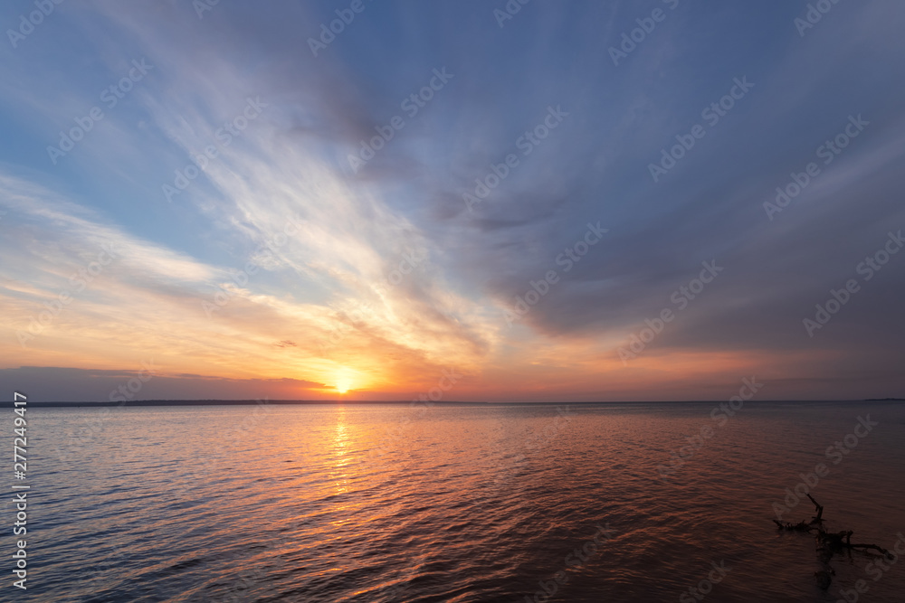 early morning sunrise on a choppy river / wind early spring landscape