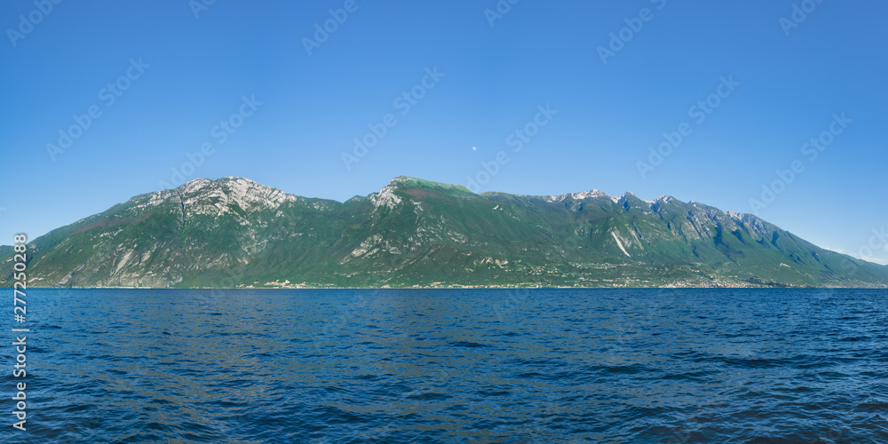 Beautiful view of Monte Baldo and Lago Di Garda coastline, Italy. View of Malcesine and Nago-Torbole on the opposite side of the lake