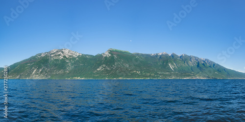 Beautiful view of Monte Baldo and Lago Di Garda coastline, Italy. View of Malcesine and Nago-Torbole on the opposite side of the lake