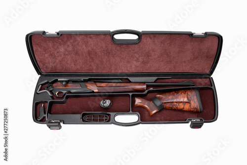 Modern semi-automatic hunting rifle with a wooden butt in an open plastic case. Isolate on a white background.