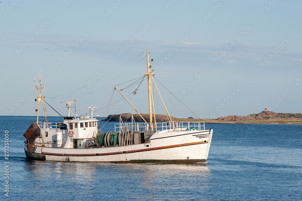 Vintage fishing boat landing fish