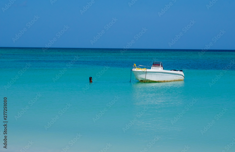 Small boat anchor in the Mexican gulf turquoise and clear water Small boat anchor in the Mexican gulf turquoise and clear water