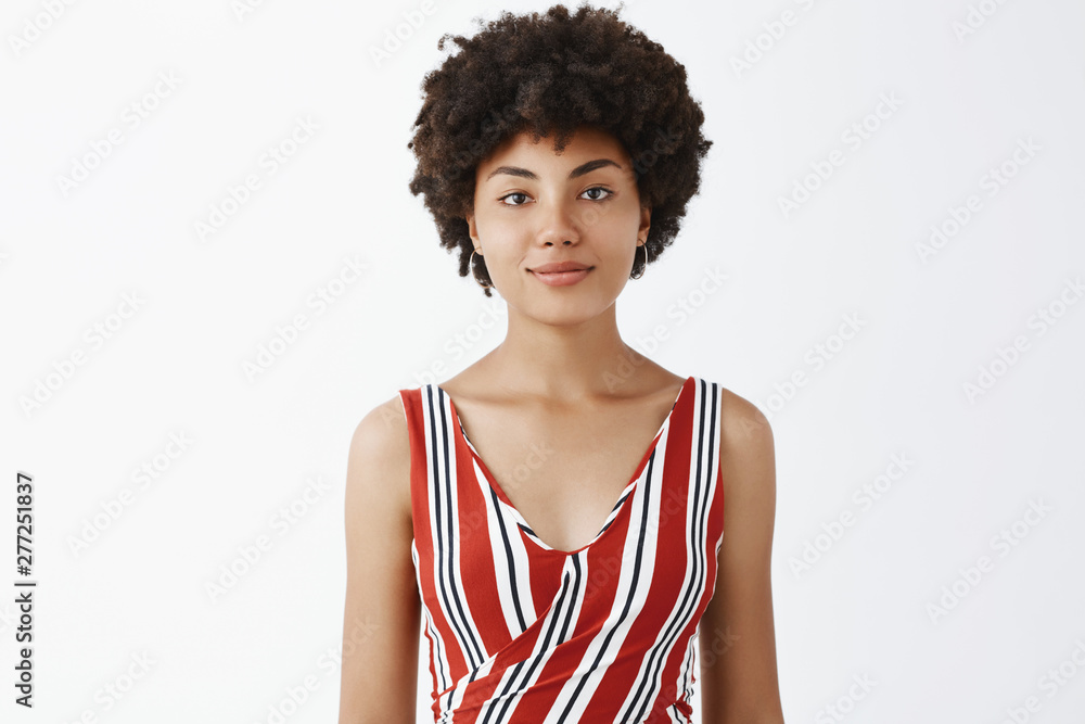 Smile a day keeps misfortune away. Portrait of cute good-looking young african american female student in striped outfit, grinning with casual carefree and relaxed expression chilling over grey wall Smile a day keeps misfortune away. Portrait of cute good-looking young african american female student in striped outfit, grinning with casual carefree and relaxed expression chilling over grey wall