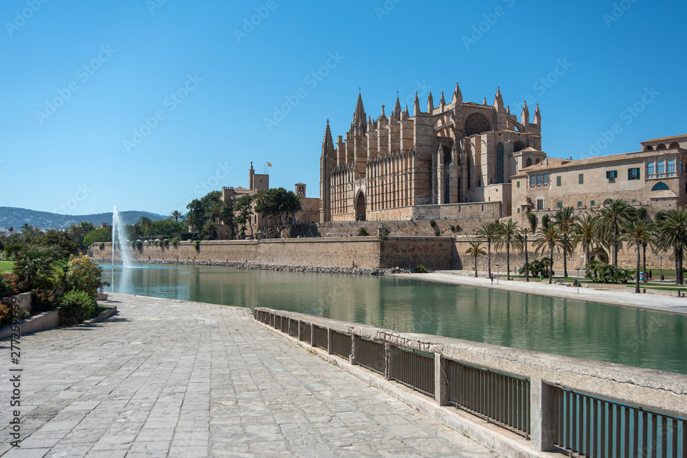 Majorca 2019: Panoramic view of Cathedral La Seu of Palma de Mallorca on a sunny summer day. Composition with pedestrian way in the foreground