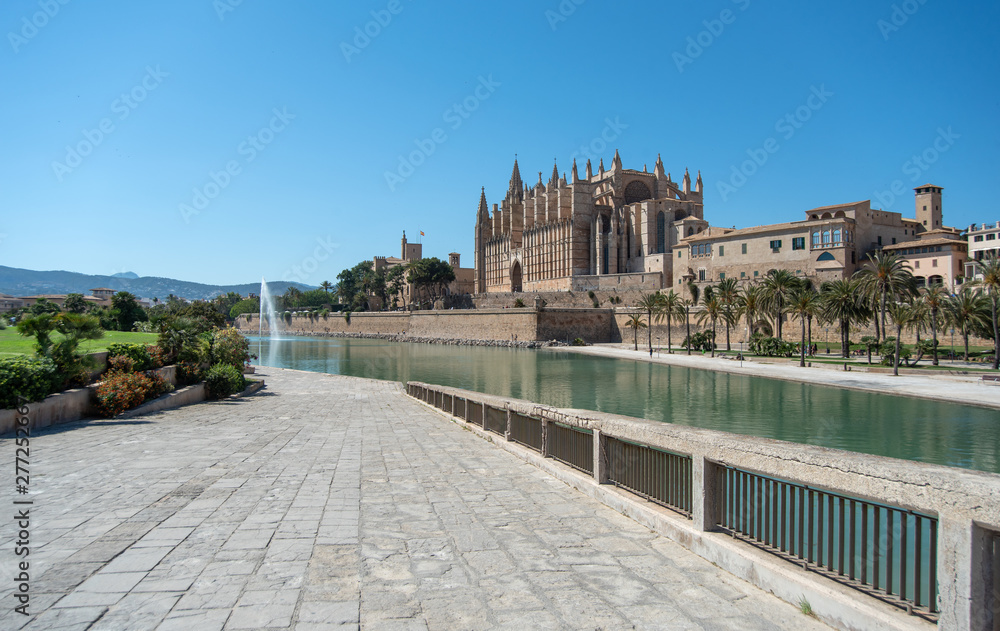 Majorca 2019: Panoramic view of Cathedral La Seu of Palma de Mallorca on a sunny summer day. Composition with pedestrian way leading to church in the foreground