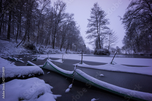 cold winter landscape with lake at dawn