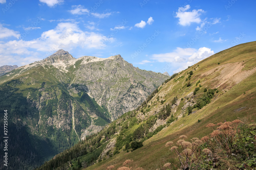 Panorama of mountains scene with dramatic blue sky in national park of Dombay