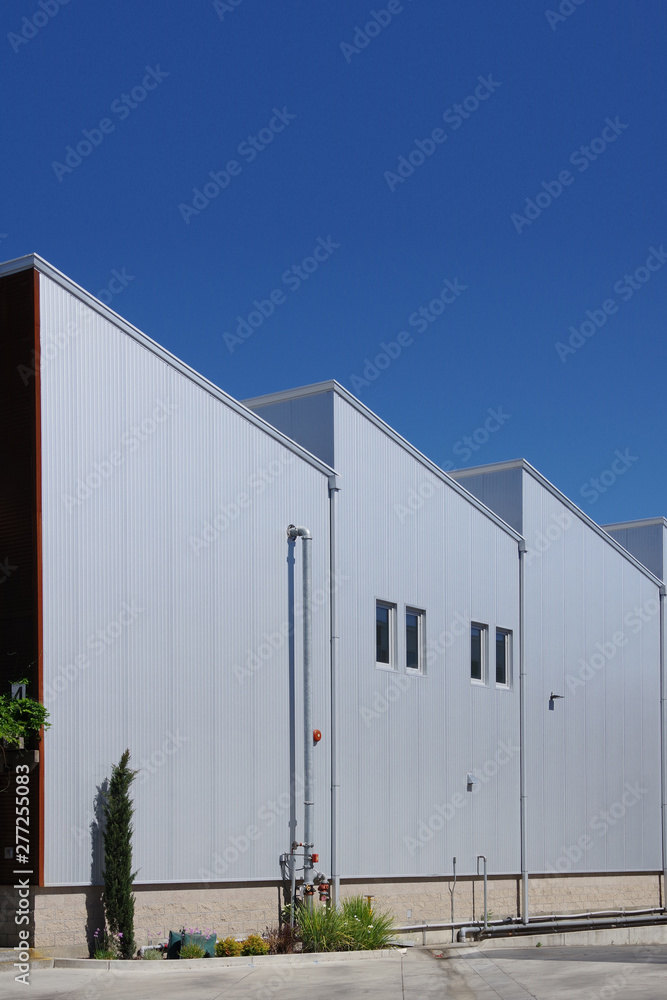 Sectional view of a modern industrial warehouse under deep blue sky Sectional view of a modern industrial warehouse under deep blue sky