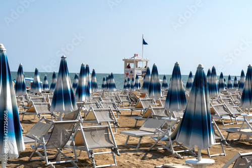 Fototapeta Naklejka Na Ścianę i Meble -  LIDO DI JESOLO, ITALY - May 24, 2019 : Umbrellas on the beach of Lido di Jesolo at adriatic Sea in a beautiful summer day, Italy. On the beach of Lido di Jesolo near Venice, Veneto region, Italy.