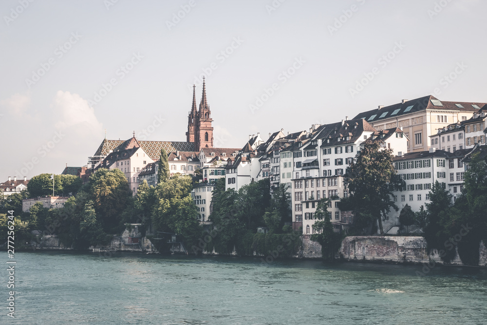 View on Basel city and river Rhine, Switzerland. People swim in water