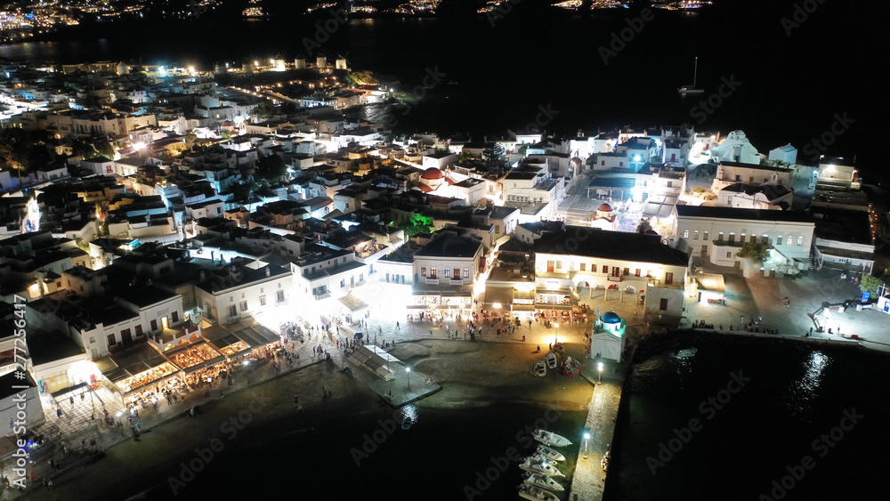 Fototapeta premium Aerial drone night shot from iconic illuminated main town of Mykonos island, Cyclades, Greece