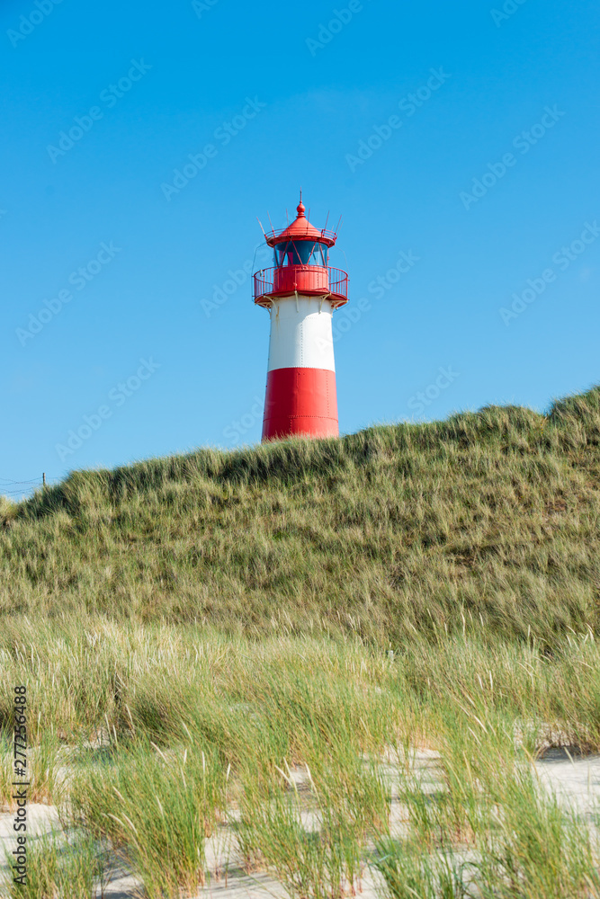 Lighthouse red white on dune. Sylt island – North Germany. Lighthouse red white on dune. Sylt island – North Germany.