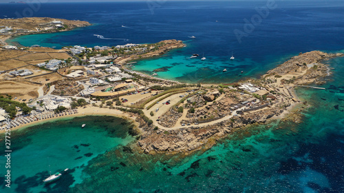 Aerial drone bird s eye view from famous beach of Paraga and Agia Anna featuring iconic Skorpios club and Santa Anna with largest pool in Europe  Mykonos island  Cyclades  Greece