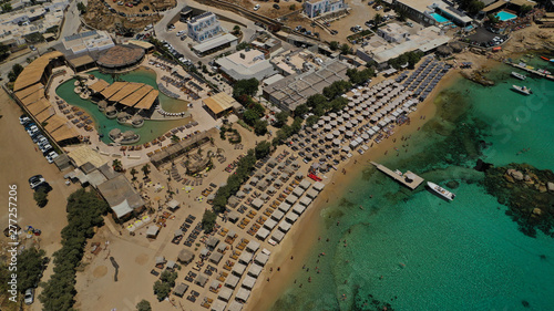 Aerial drone bird's eye view from famous beach of Paraga and Agia Anna featuring iconic Skorpios club and Santa Anna with largest pool in Europe, Mykonos island, Cyclades, Greece