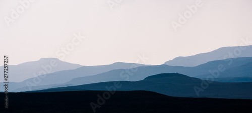 Isle of Skye - misty island landscape - hills silhouette covered in mist © lukasz_kochanek