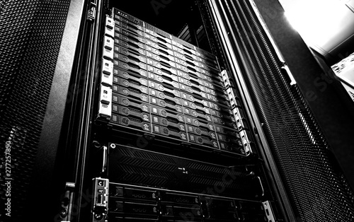 Blade server in rack cluster hard drives storage in internet data center room black and white tone photo