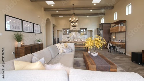 Living Room Big Space Open Floor Plan Rise from Couch. view moves up on a large room with living room, dining room and kitchen in open concept