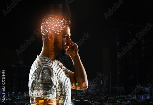 Double exposure of man with glowing brain and city photo