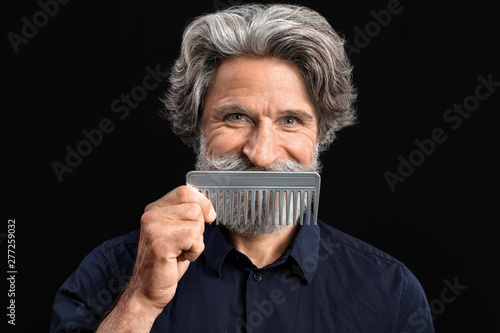 Mature male hairdresser on ...