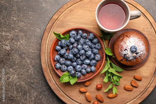 Fototapeta Naklejka Na Ścianę i Meble -  Fresh blueberry with muffin and tea on board