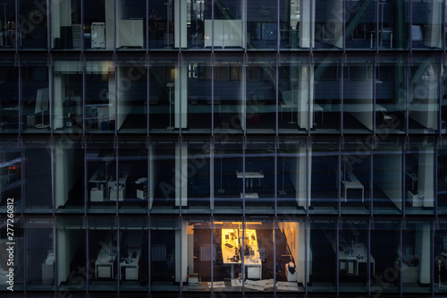 working late: single illuminated office at night