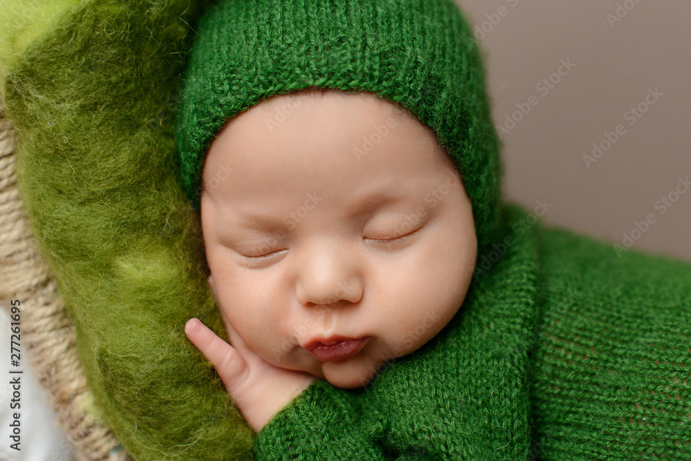 Sleeping newborn boy on a brown background. Sleeping newborn boy on a brown background.