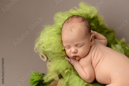Sleeping newborn baby on a brown background 