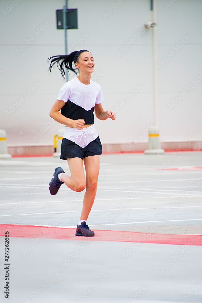 fitness girl running outdoor, urban city background