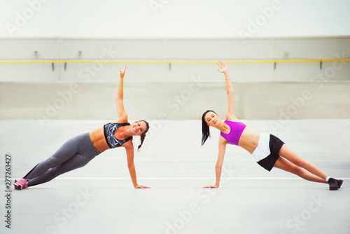 two girls exercise, fitness with friend, urban background, outdoor 