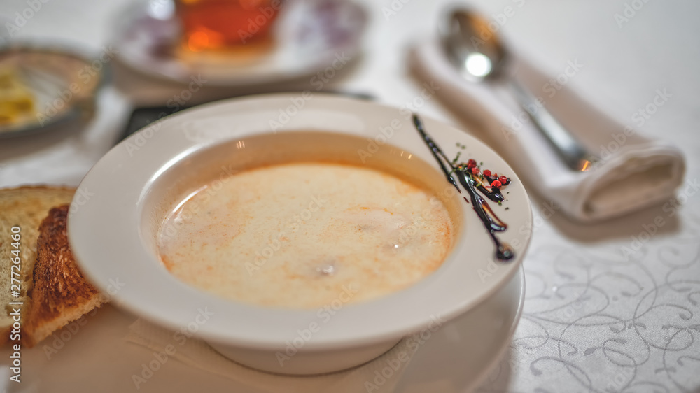 a plate of fish cream soup on the table a plate of fish cream soup on the table