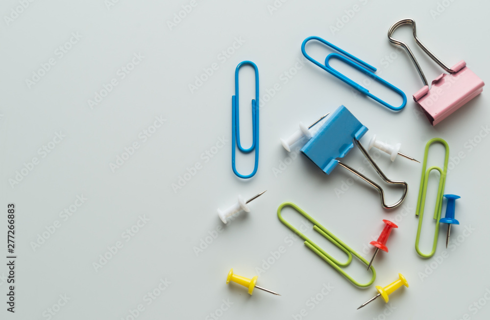 colorful metallic clamps and paper clips on white background