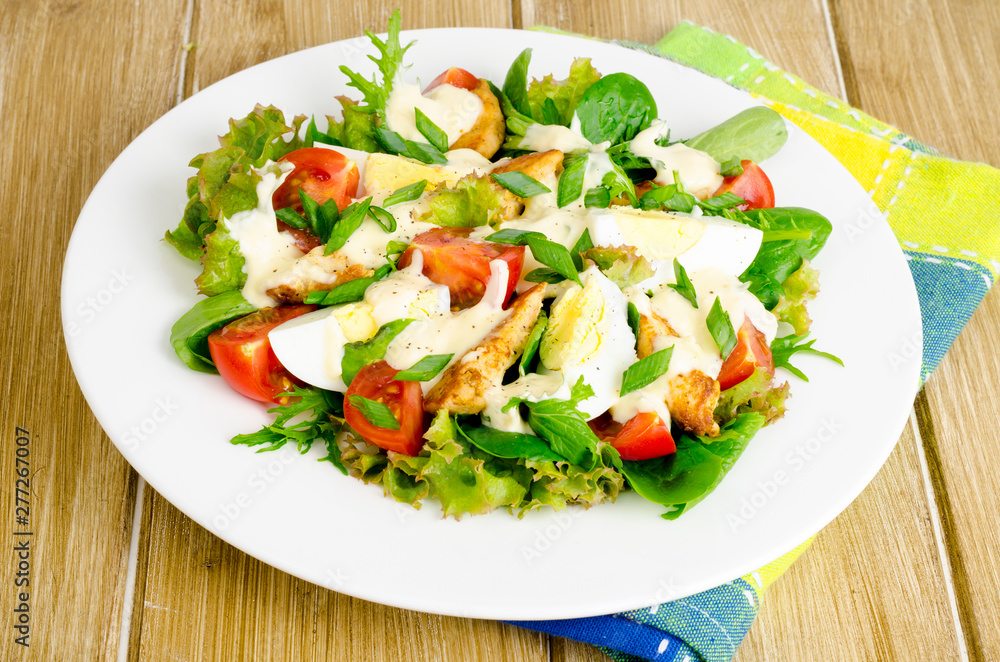 Salad of fresh vegetables, eggs, chicken meat with white sauce. Salad of fresh vegetables, eggs, chicken meat with white sauce.