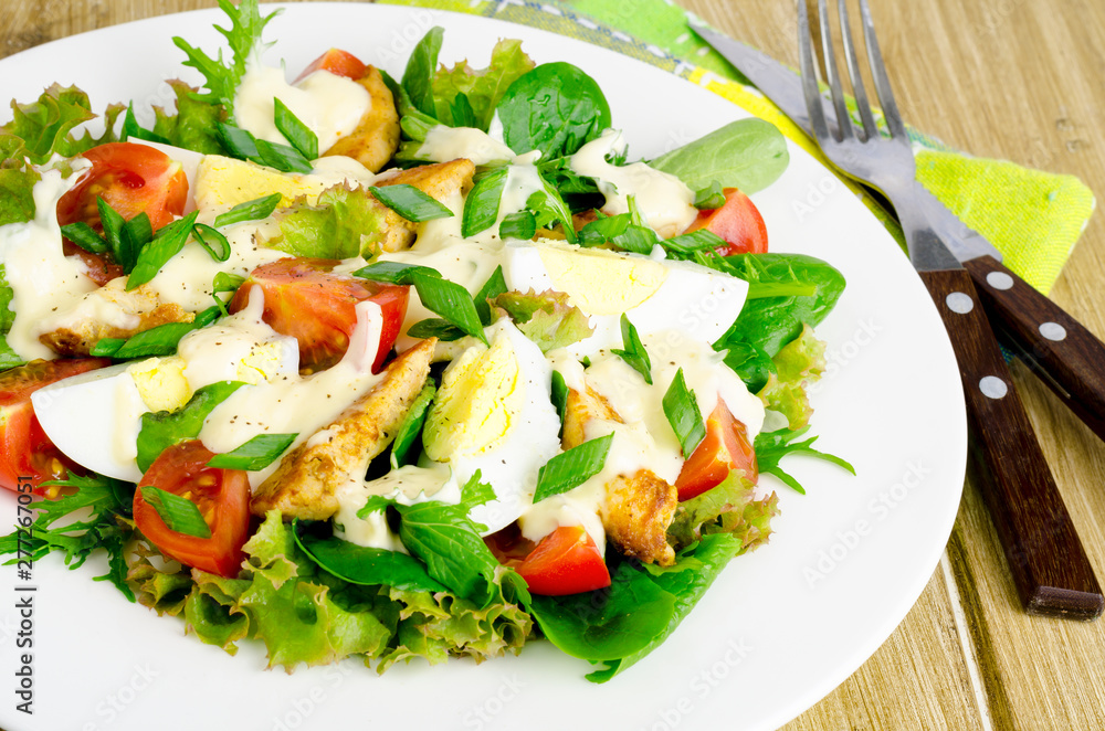 Salad of fresh vegetables, eggs, chicken meat with white sauce. Salad of fresh vegetables, eggs, chicken meat with white sauce.