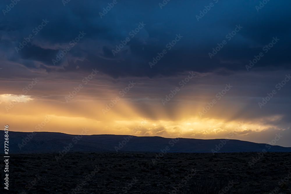 Sun rays and storm clouds at sunset Sun rays and storm clouds at sunset
