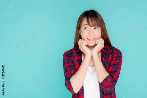 Beautiful portrait young asian woman smiling and surprise wearing travel summer fashion in vacation isolated on blue background, girl shocked expression and emotion, holiday amazing concept.