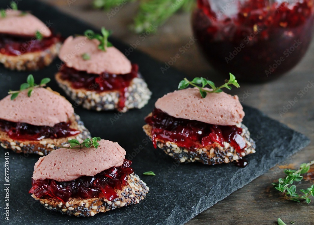 Canapes snacks with chicken pate and onion marmalade (chutney)