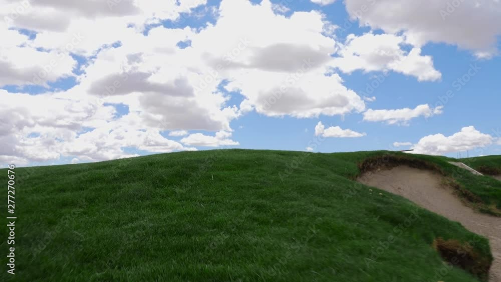 Golf View Walking Up to Green from Bunker. low angle view walking up to a golf green from a bunker area Golf View Walking Up to Green from Bunker. low angle view walking up to a golf green from a bunker area