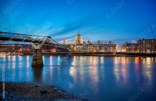 St. Paul's Cathedral across Millennium Bridge and the River Thames in London, UK.