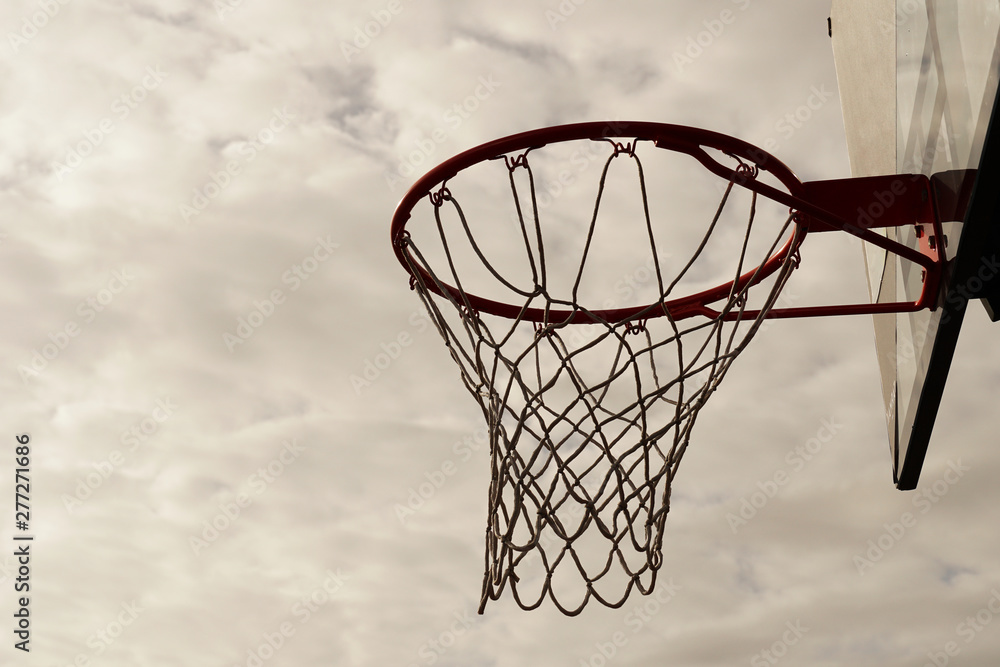 movement of basketball hoop in sport court with cloud sky background