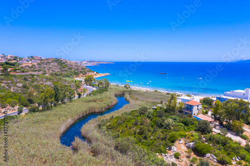Famous sandy beach of Almyros and the river near Agios Nikolaos, Crete, Greece.
