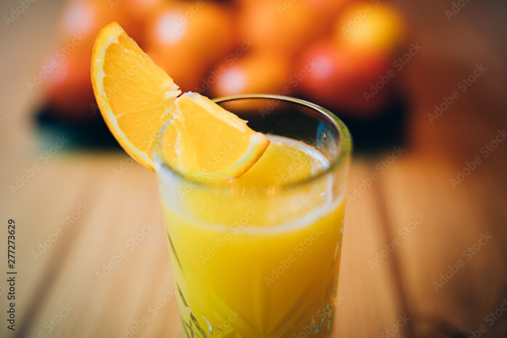 Glass of fresh orange juice on wooden table Glass of fresh orange juice on wooden table