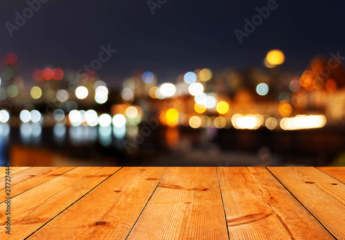 perspective of brown wooden board over bokeh