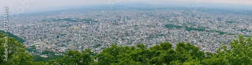 Panorama beautiful landscape view of Sapporo City from Viewpoint of Moiwa mountain in cloudy day, Hokkaido, Japan.