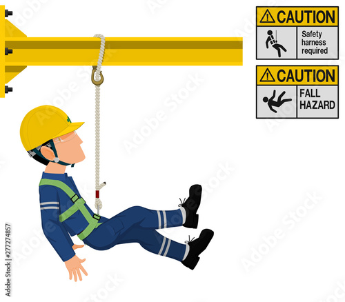 An industrial worker with safety harness is working at height photo