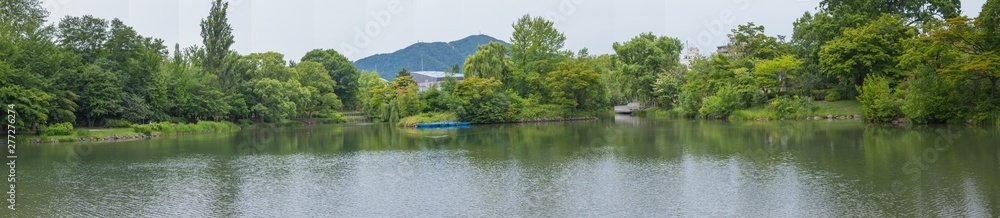 Panorama beautiful landscape view of Lake surrounded with green trees in Nakajima Park (Koen) in Sapporo City, Hokkaido, Japan.