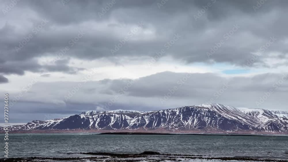 Time lapse of the Atlantic ocean and the clouds above Esja Mountain in winter near Reykjavik, Iceland. Time lapse of the Atlantic ocean and the clouds above Esja Mountain in winter near Reykjavik, Iceland.