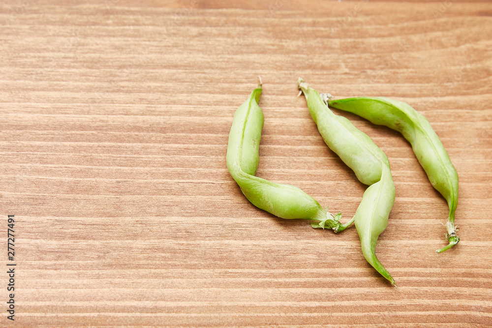 Ugly organic home grown pea on wooden background. Trendy ugly food.Top view, copy space. Ugly organic home grown pea on wooden background. Trendy ugly food.Top view, copy space.