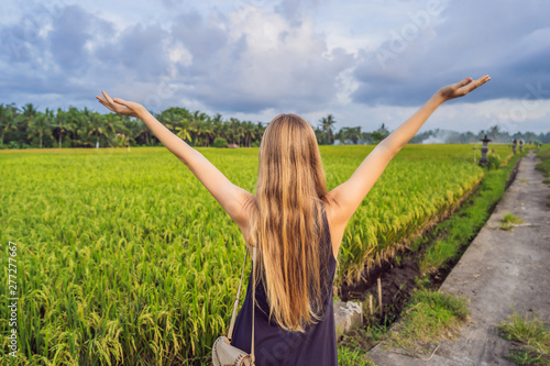 Women tourists enjoy the panoramic view of the beautiful Asian scenery of rice fields