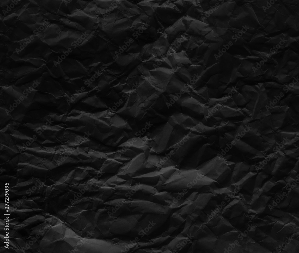Fototapeta premium Black wrinkled paper texture background.